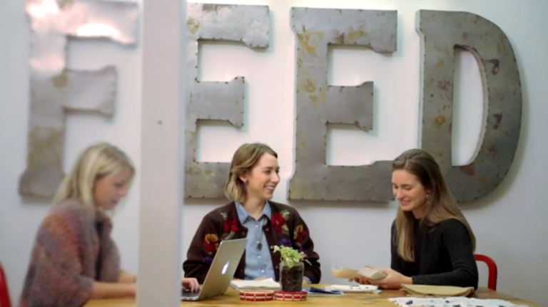Lauren Bush Lauren sits with two others at a work table